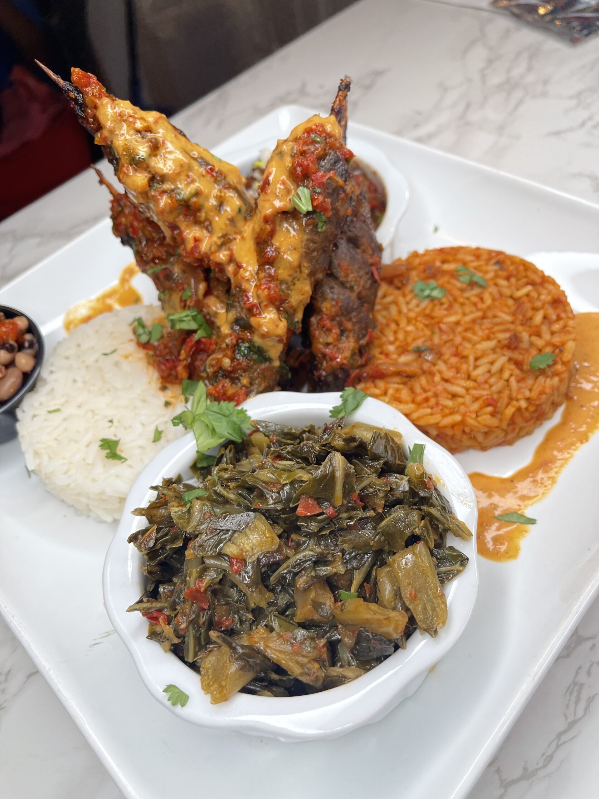 white rice collard green goat meat platter